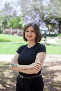 Photo of Jordan Galczynski, wearing a black shirt in an outdoor setting.