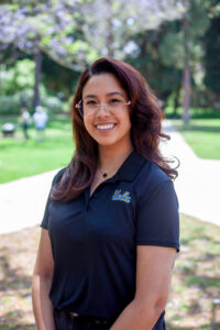 Photo of Genevieve Johnson wearing a UCLA shirt in an outdoor setting.