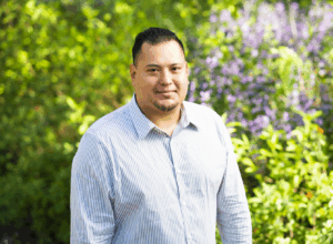Picture of Alberto Salazar standing in a garden setting.
