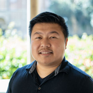 Picture of Chris Cao in a black shirt in an outdoor setting.