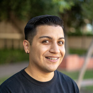 Picture of Kevin Melendez in a black shirt in an outdoor setting.