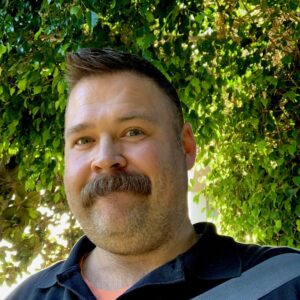 Picture of Lloyd Nicks in a black shirt in an outdoor setting.